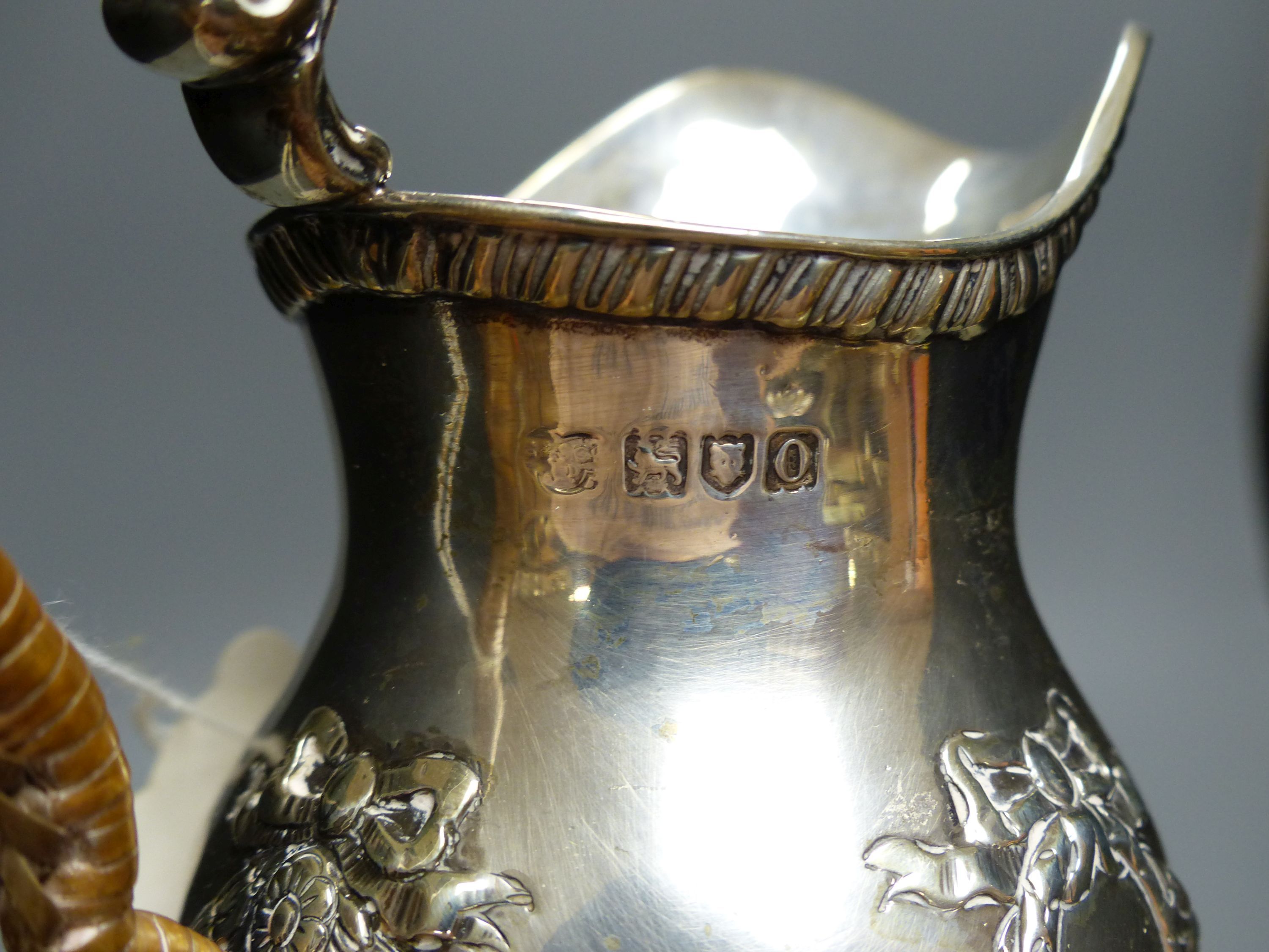 An Edwardian silver cream jug, with rattan handle, Goldsmiths & Silversmiths Co Ltd, London, 1909, 15.5cm, 8oz.
